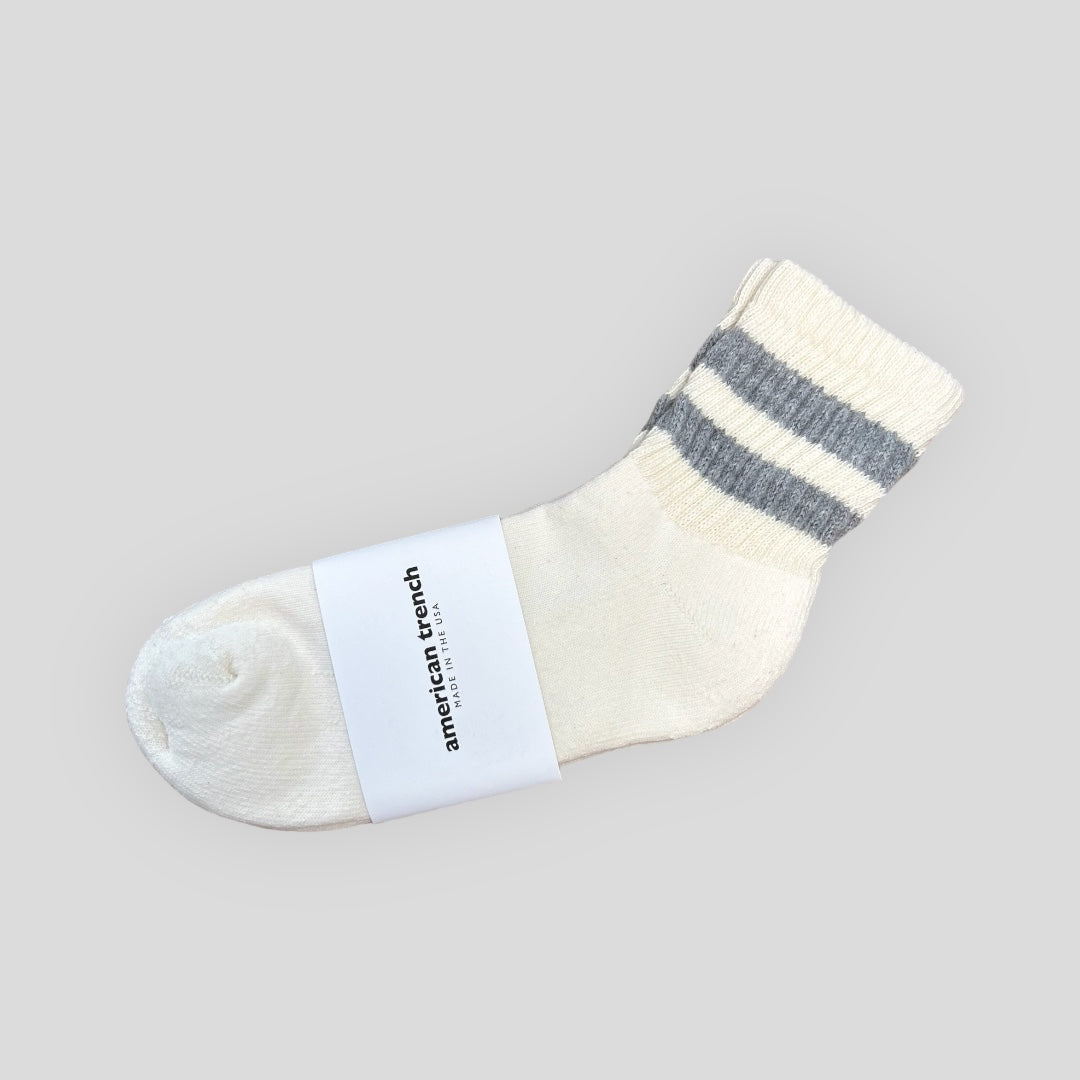 This is a white Quarter Crew Men's sock has two heather grey stripes on the shaft of the sock and a padded footbed for extra comfort. Pairs well with shorts or sandals.
