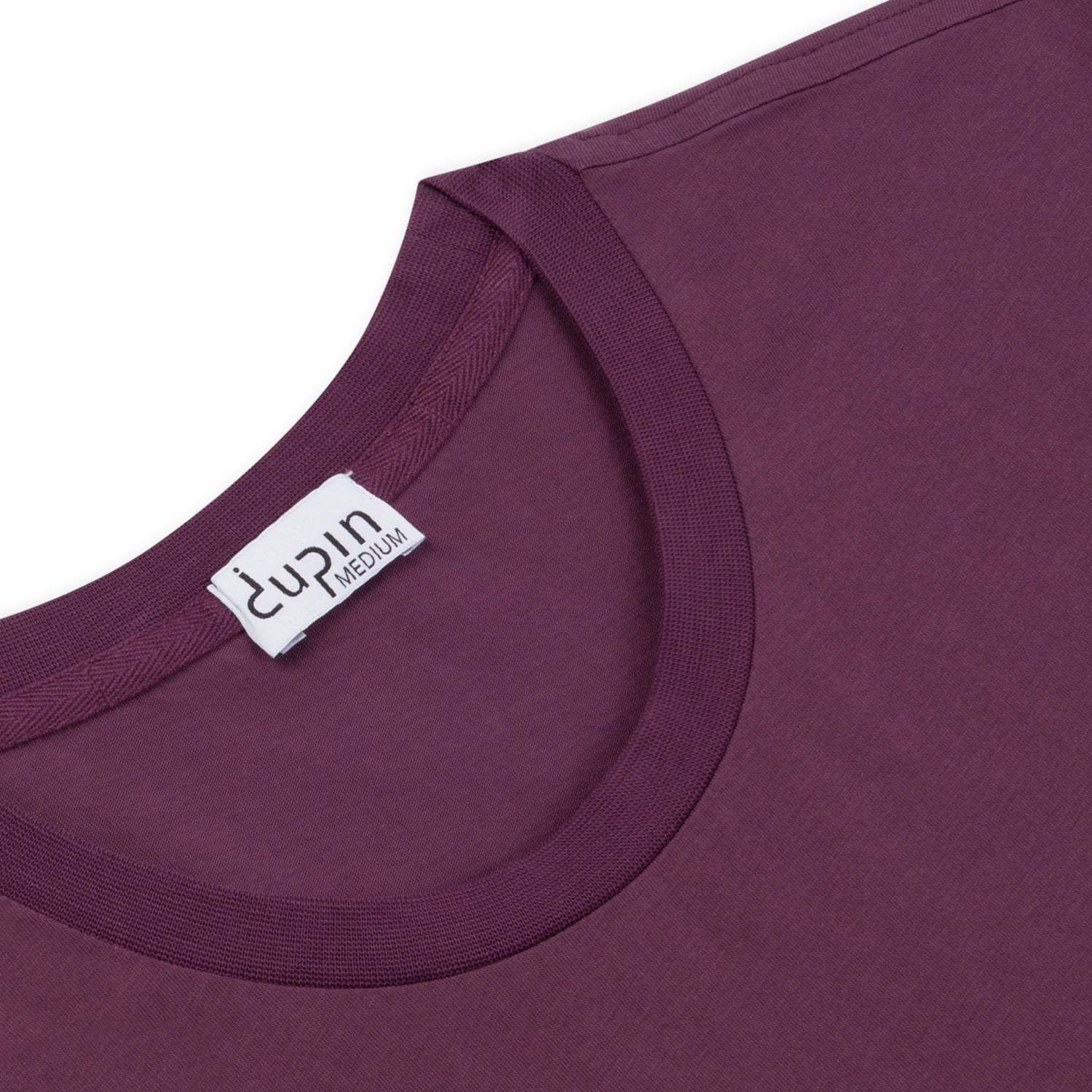 This image is a close up photo of the neck detail on the Dupin Essential Tee. The color is light aubergine, which is a woodsy purple color. The Dupin size label is on the center back of the color. 